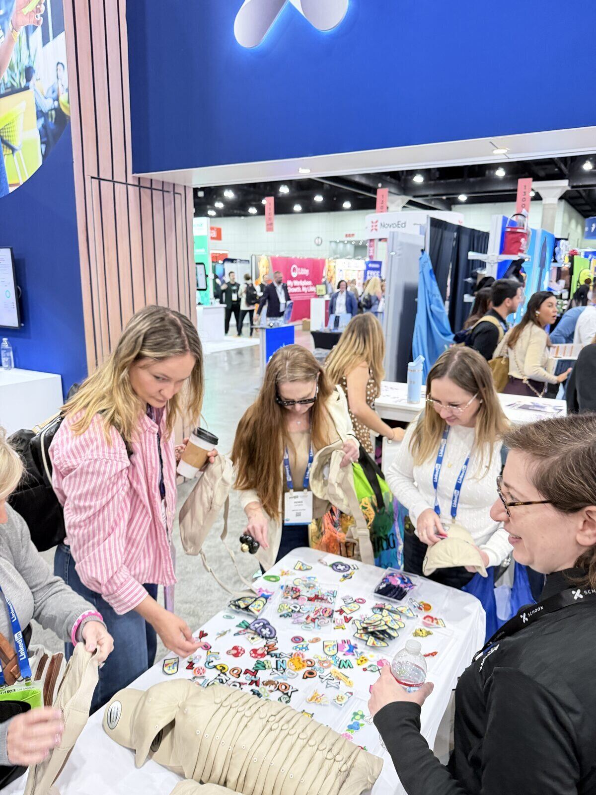 Convention guests choosing chenille letter patches at a live customization table